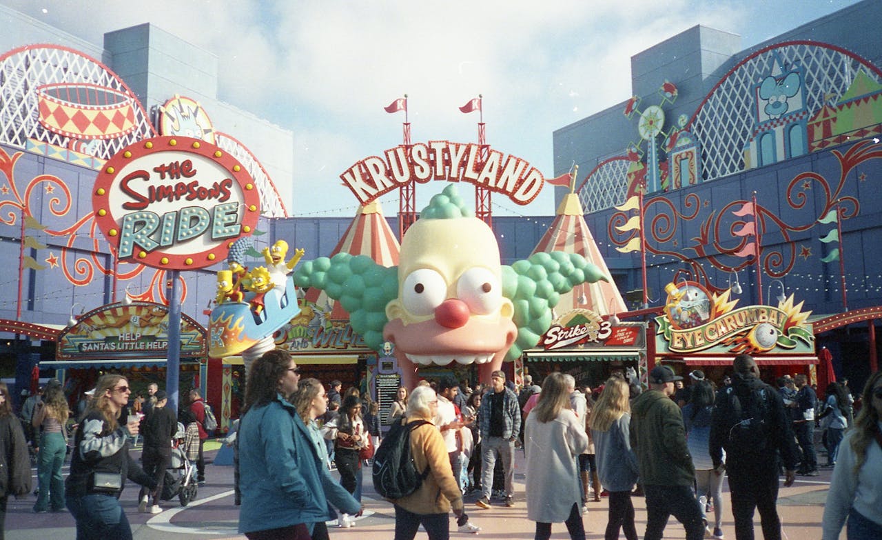 Crowded entrance of Krustyland at Universal Studios featuring The Simpsons Ride.