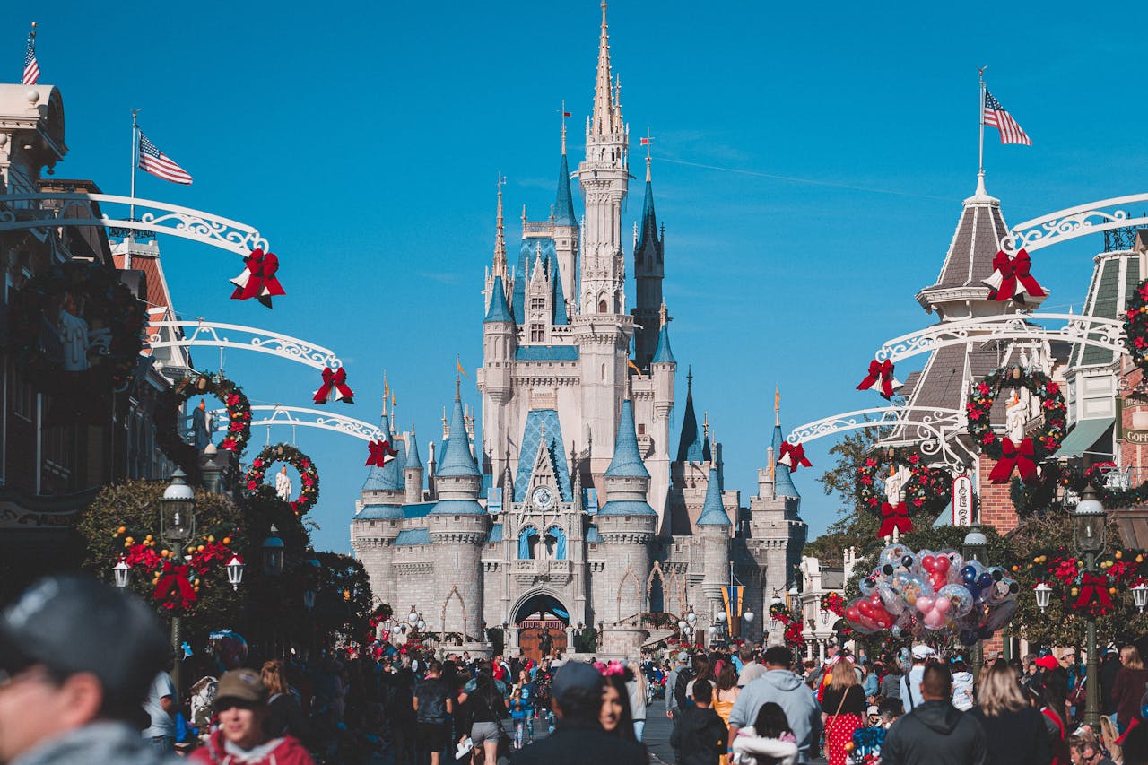 A busy day at Orlando's Magic Kingdom with crowds enjoying holiday decorations.